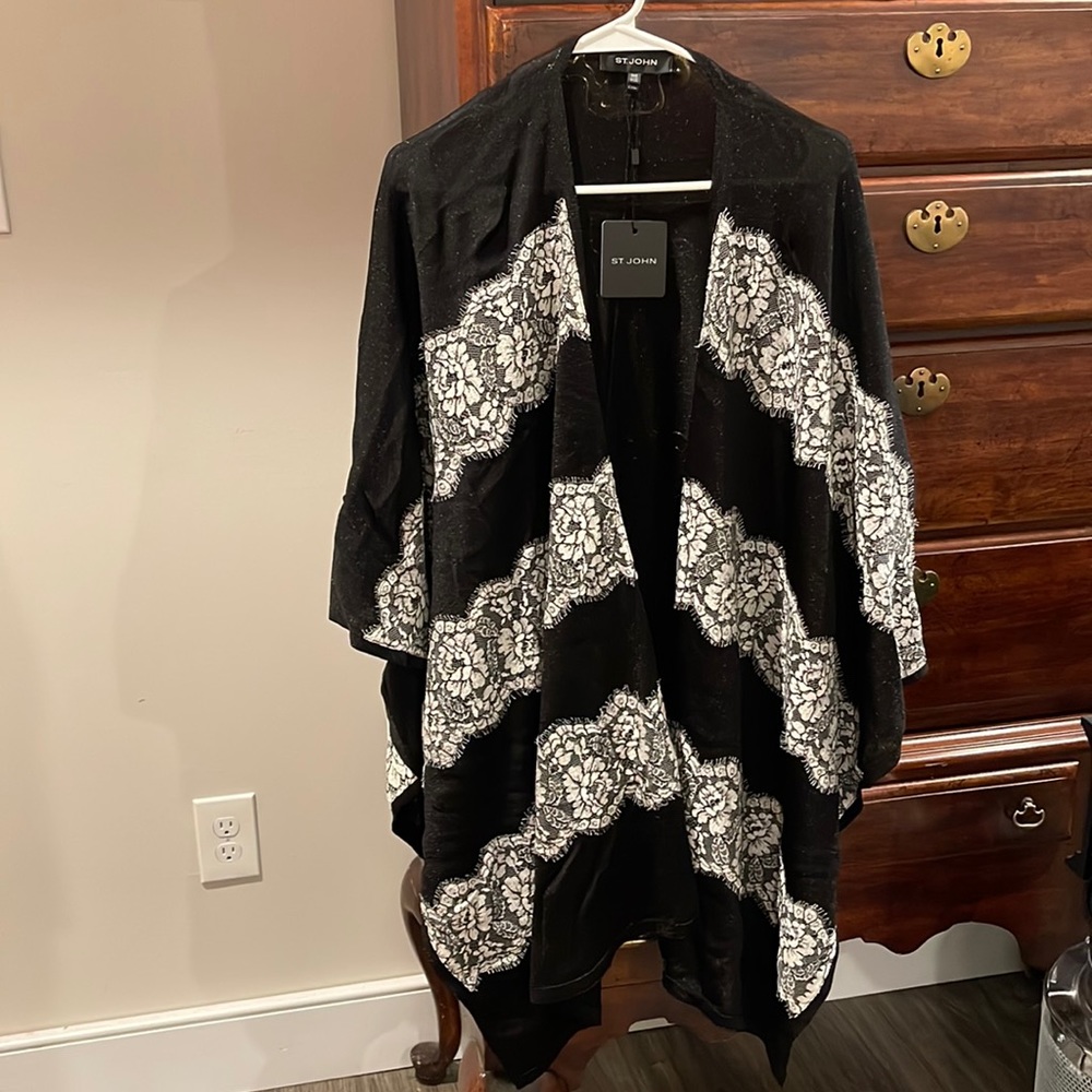Beautiful Black Cape with shimmer and lace . With original tags . Never worn